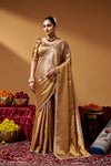 Full-length view of a model wearing a Kanjivaram zari tissue saree with hand embroidery and tube beadwork.
