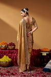 Front view highlighting the saree drape, zari texture and embellished border.