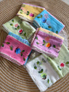 Mint green, yellow, blue, pink and white floral sarees arranged together