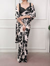 Model wearing a blush pink and black abstract printed satin silk saree with blouse